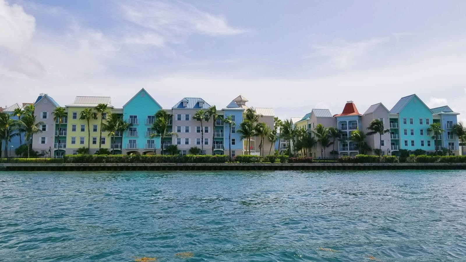 Pastel apartment buildings and palm trees along Nassau harbor