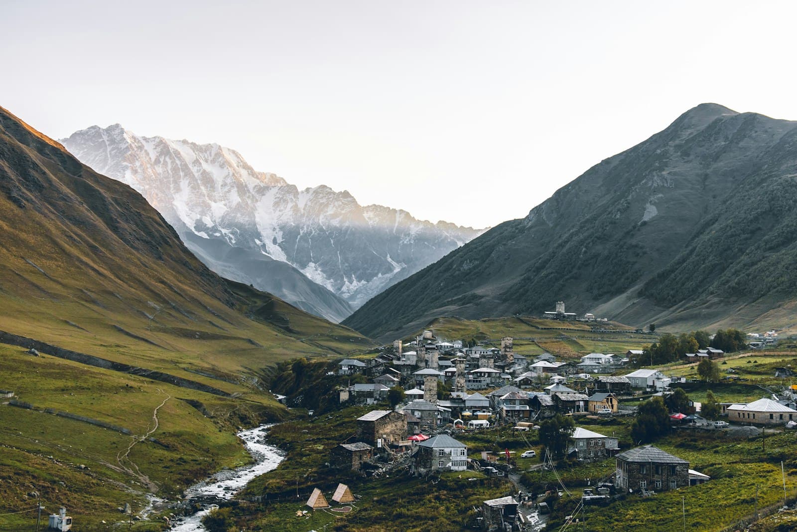 Stone towers of Ushguli in Svaneti below a snow-covered Caucasus ridge