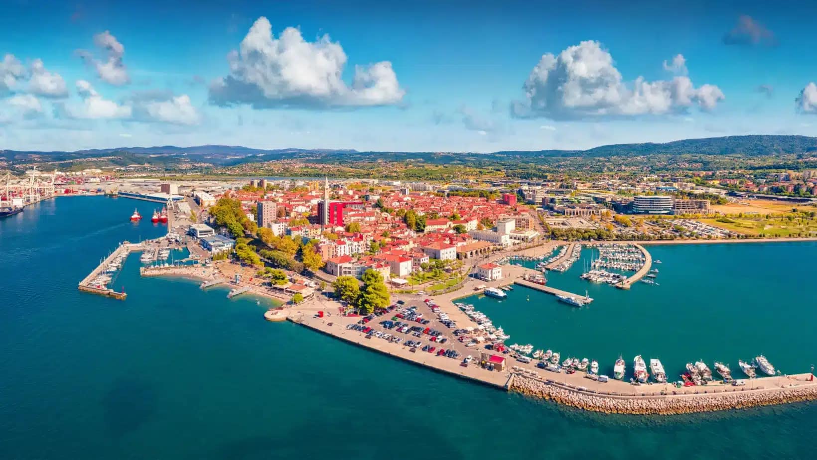 Aerial view of Koper's harbor, marinas and red-roofed old town on Slovenia's Adriatic coast