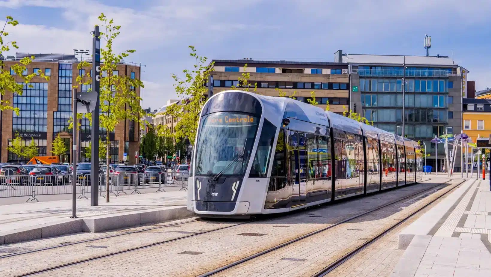 A modern tram stopping at a station in Luxembourg City