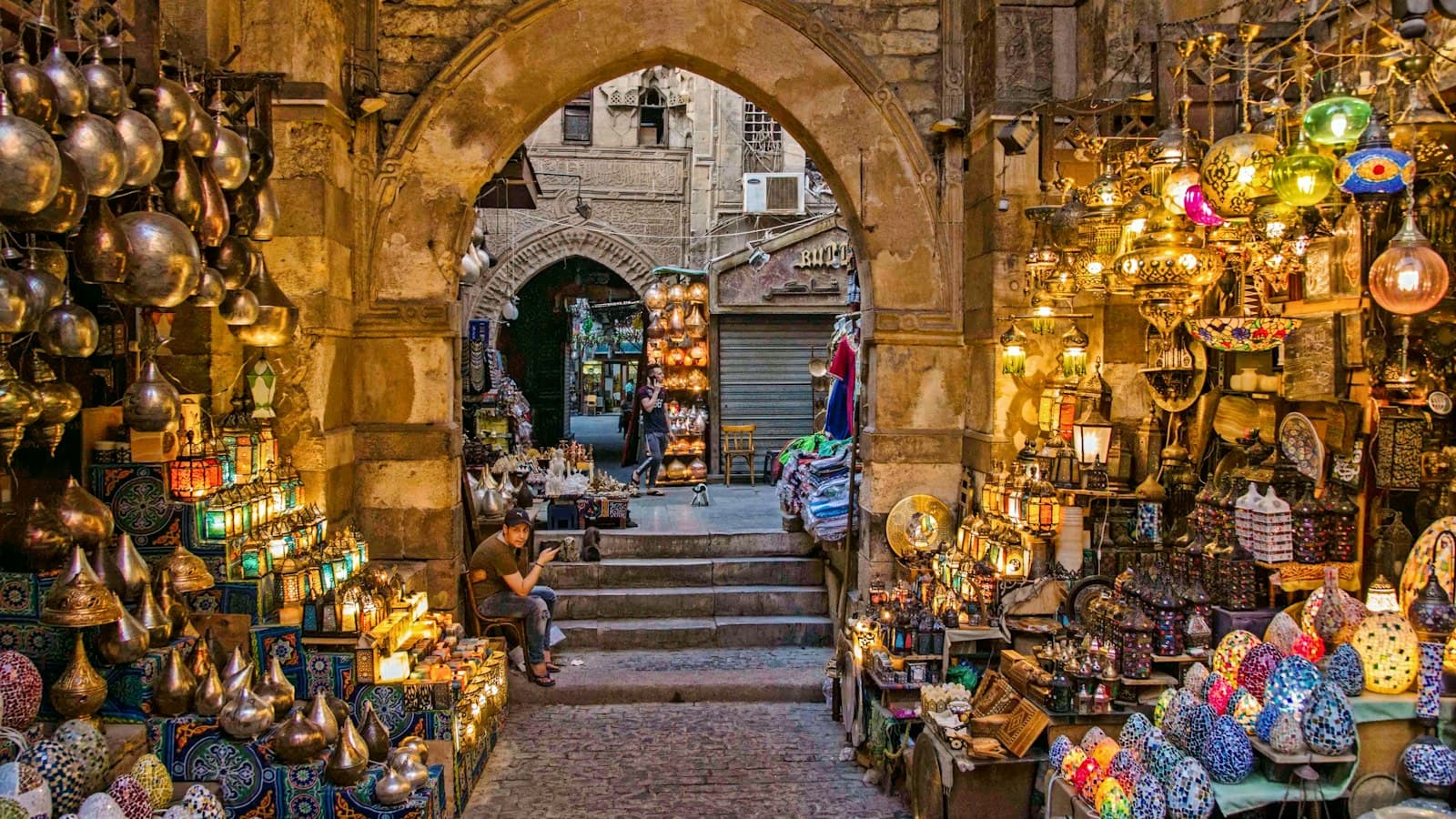 Lantern shops under a stone archway in Cairo's Khan el-Khalili bazaar