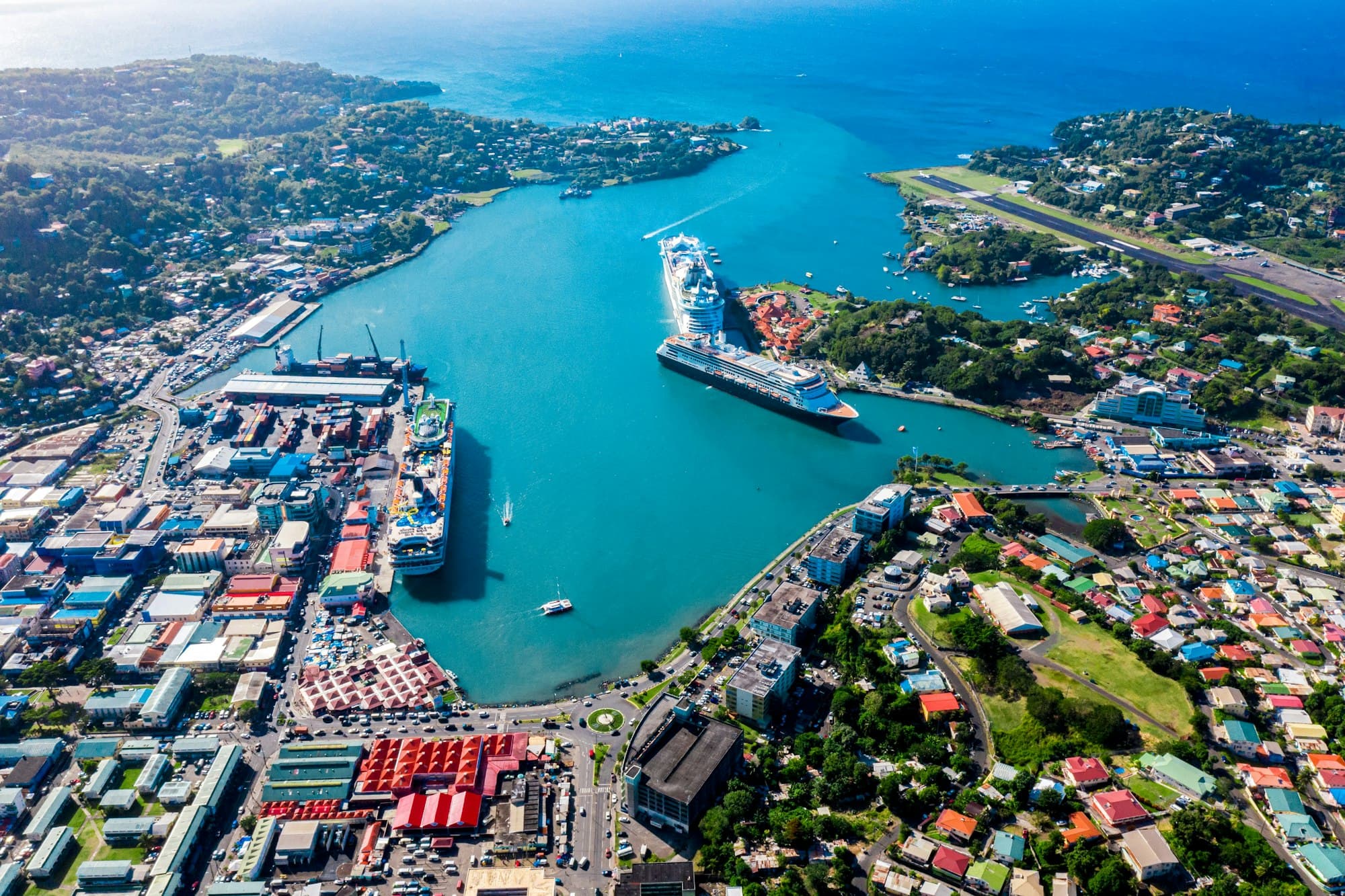 Aerial view of Castries harbor in Saint Lucia with cruise ships, the waterfront, and hillside neighborhoods