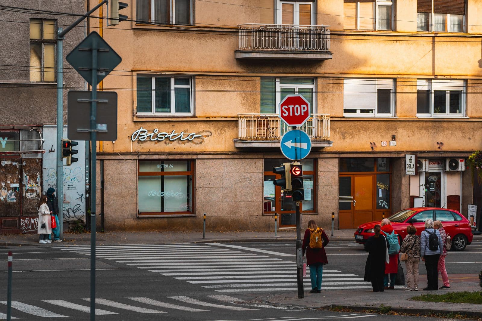 People waiting at a crosswalk on an autumn afternoon in Bratislava