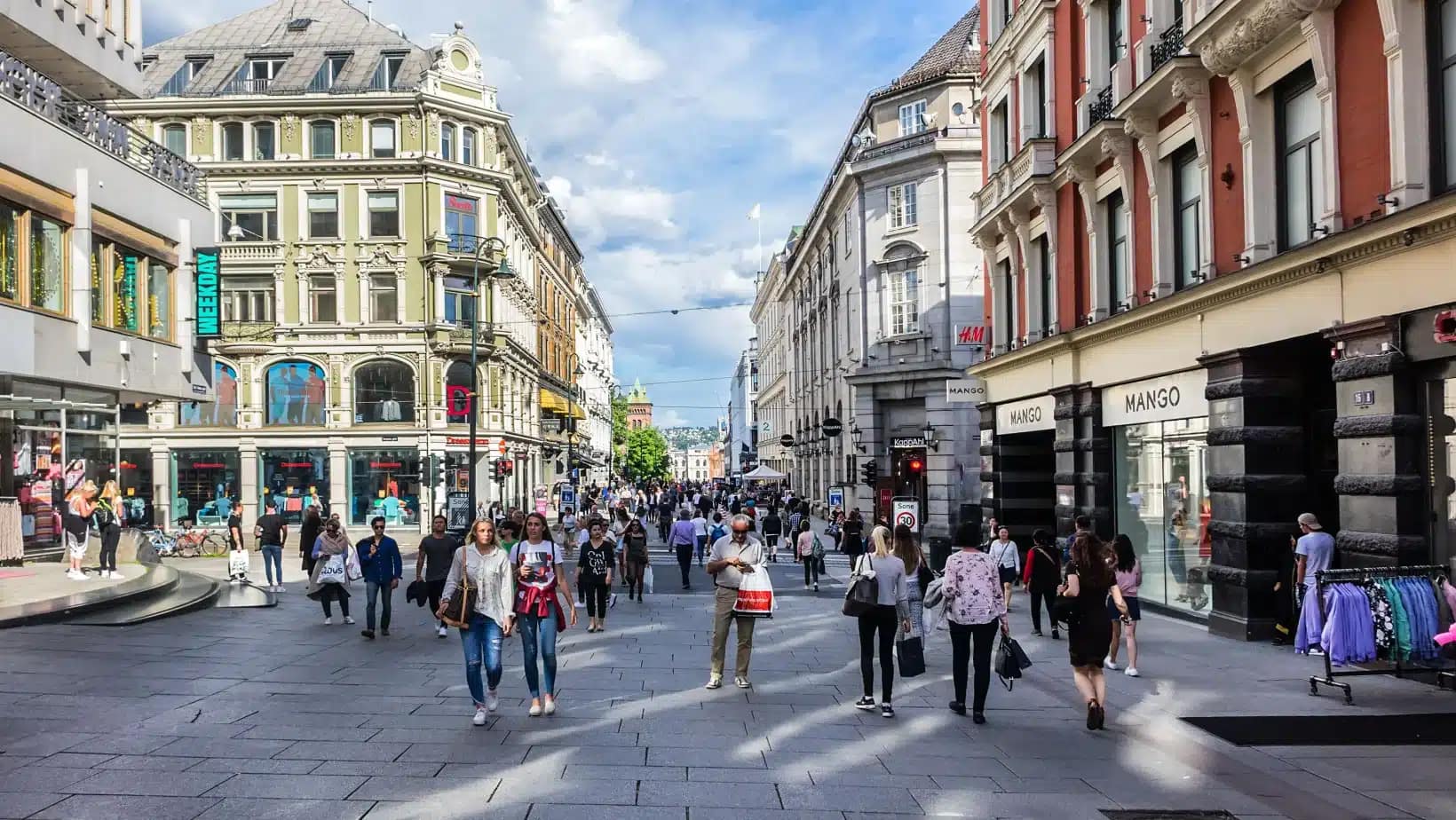 People walking along a pedestrian shopping street in central Oslo