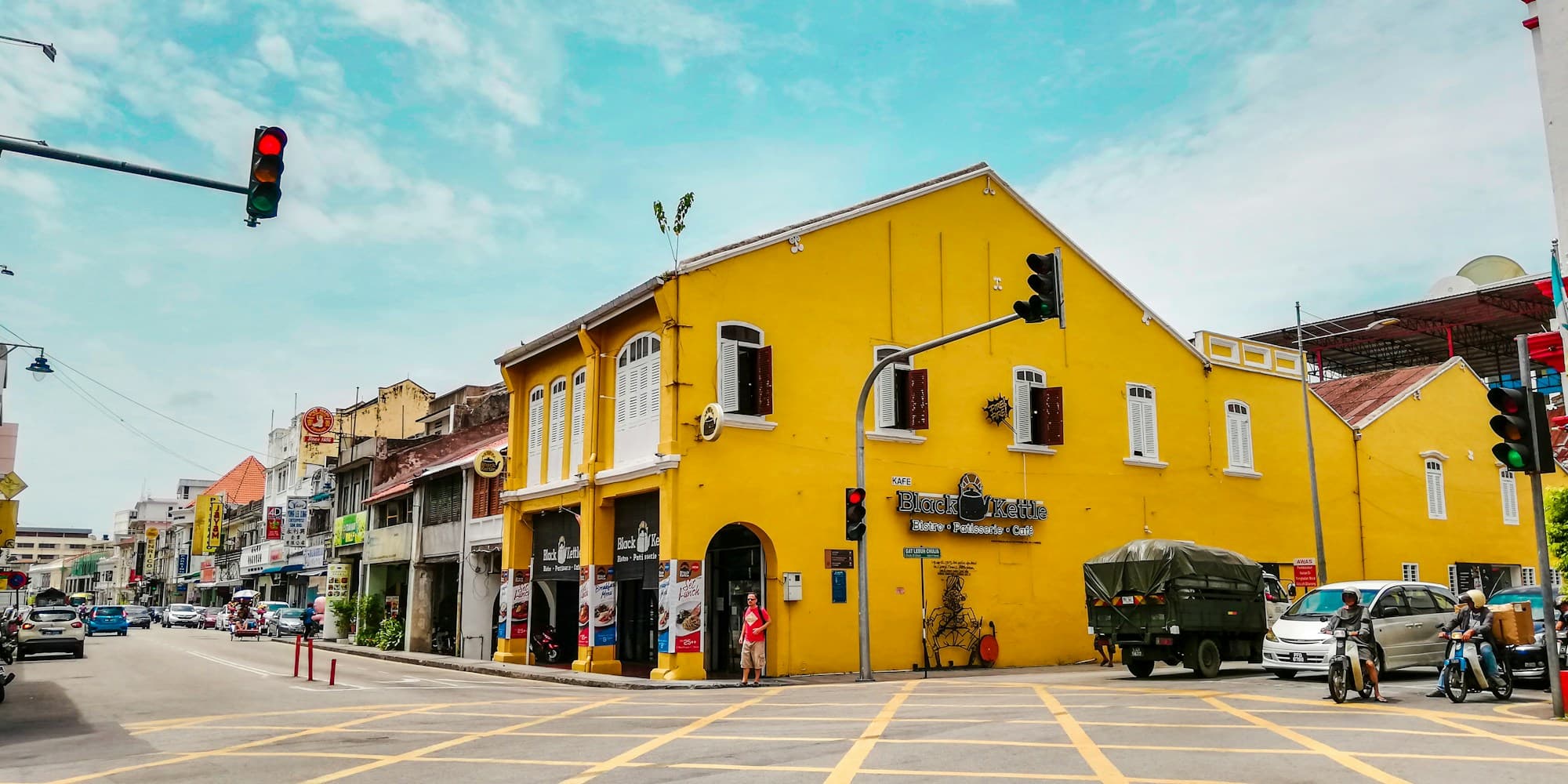 Yellow colonial shophouses at a street corner in George Town, Penang