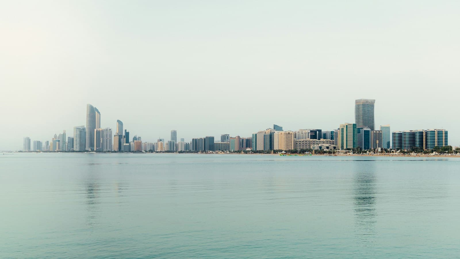 Abu Dhabi skyline seen across calm water