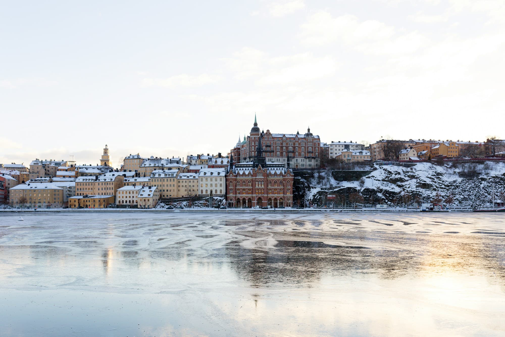 Snow-covered Södermalm across the frozen water in Stockholm in winter