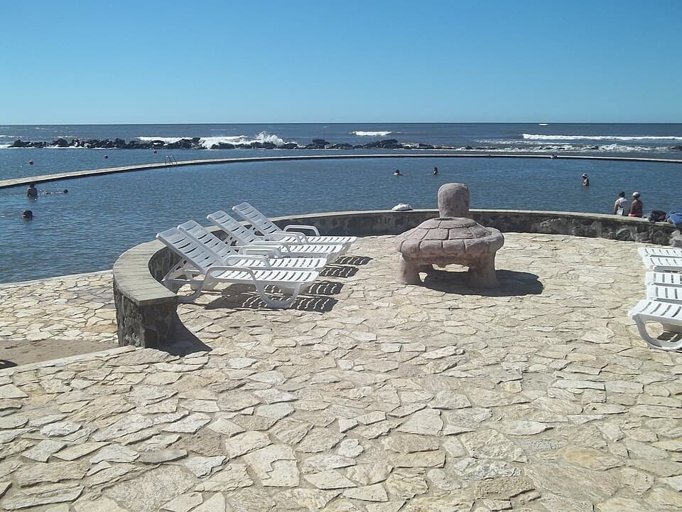 Stone terrace with lounge chairs beside a seawater pool at Playa Salinitas on El Salvador's Pacific coast