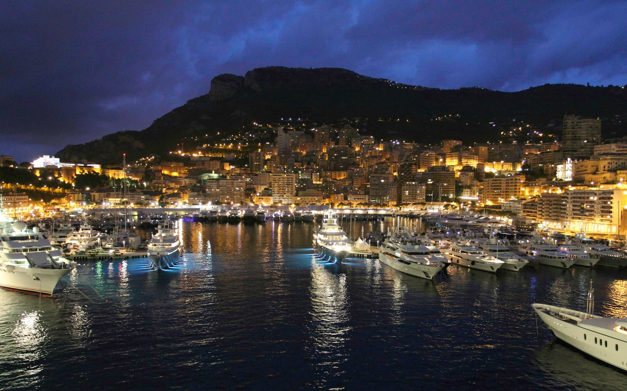 Port Hercule and the Monaco hillside lit up at night