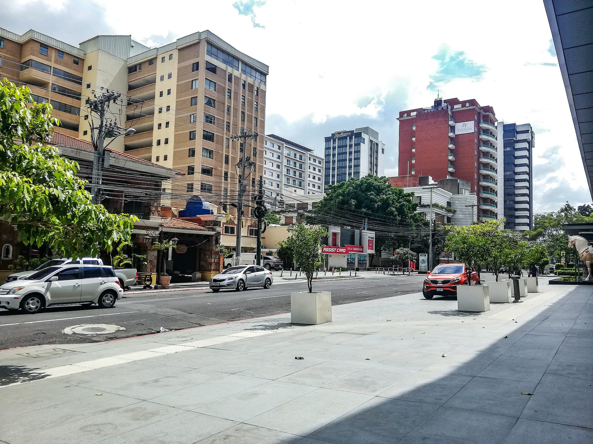 Office and apartment towers along a wide sidewalk in Zone 10, Guatemala City's business district
