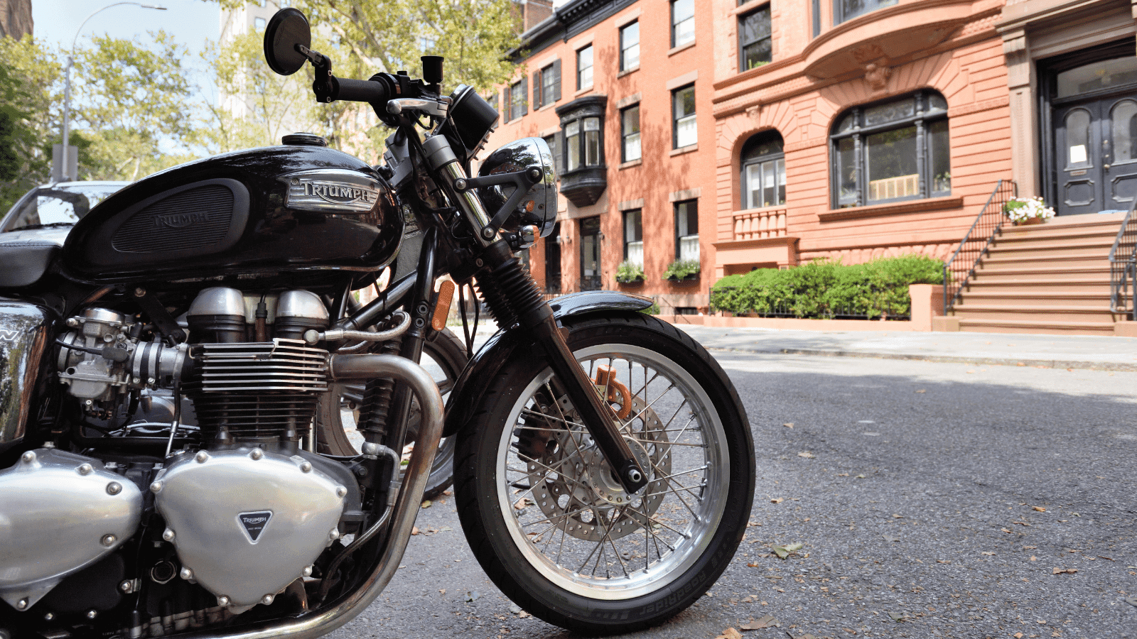 A motorcycle parked on a road in a city.