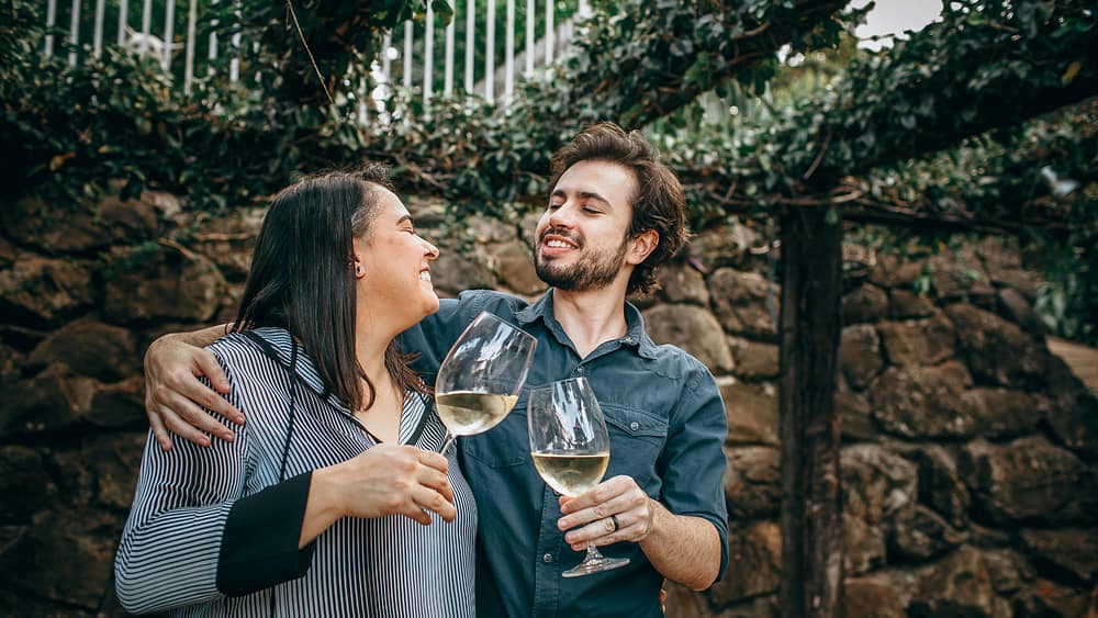 A couple sharing a glass of wine outdoors