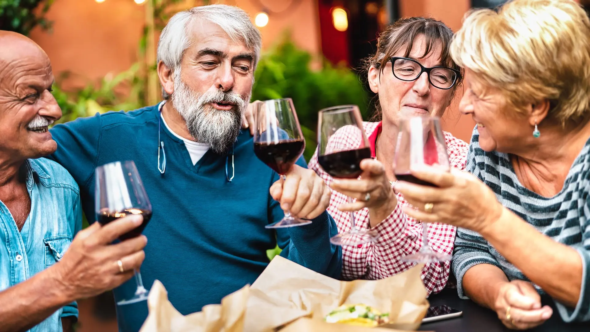 Friends toasting with wine at a Move Abroad Mixer