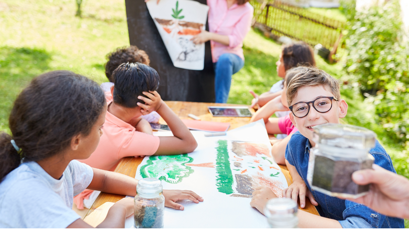international school kids learn a lesson outside