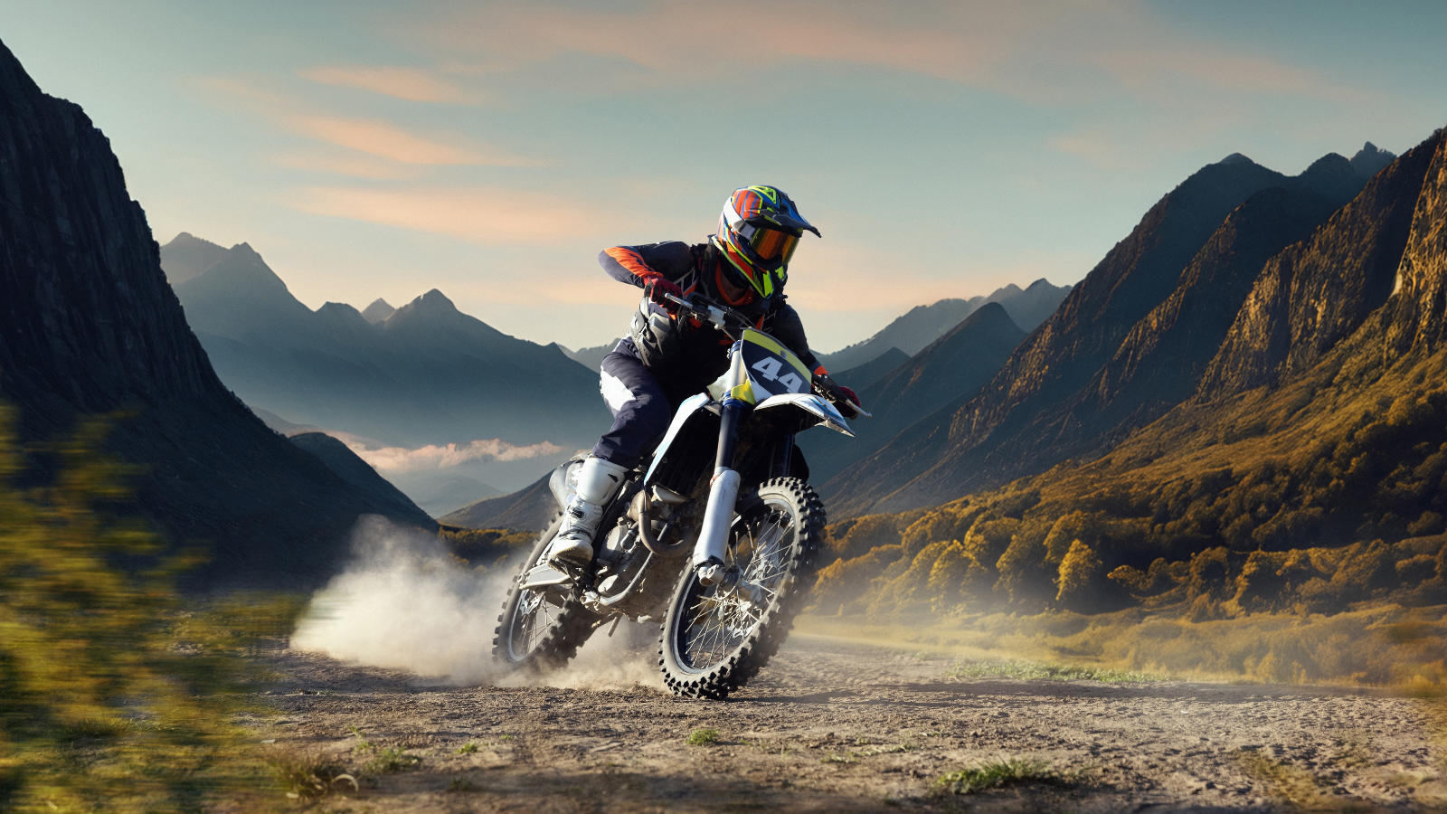 A man on a motorcycle surrounded by mountains.